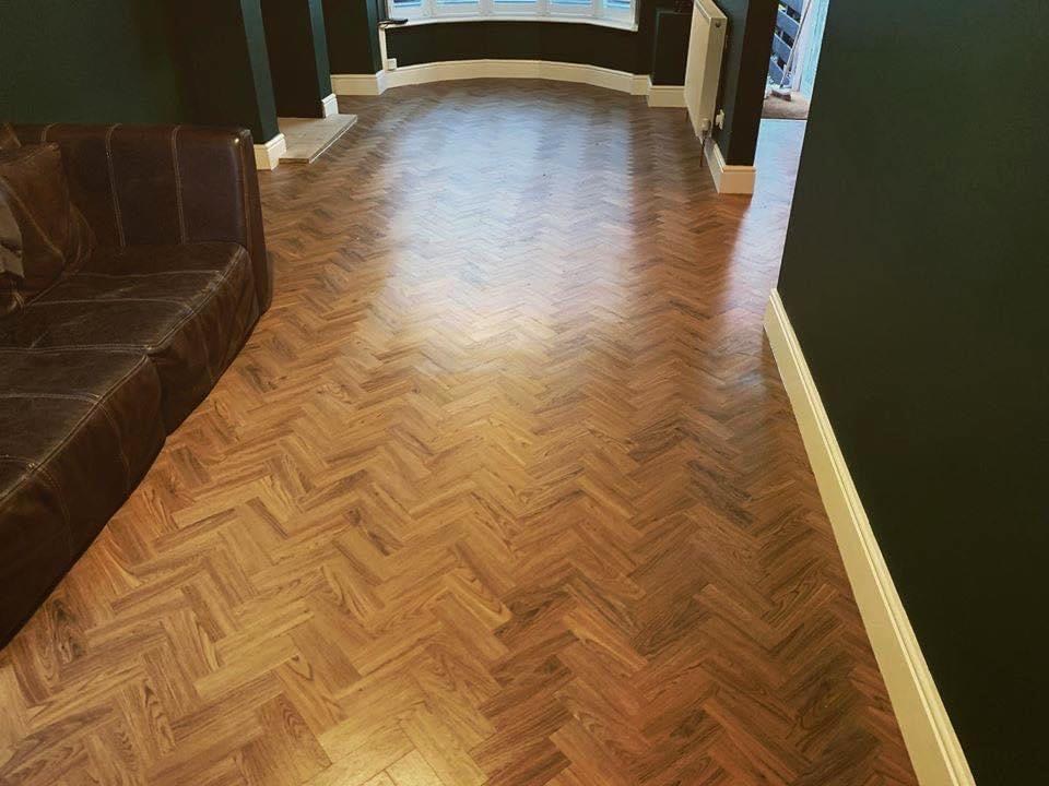 Herringbone flooring down a long hallway