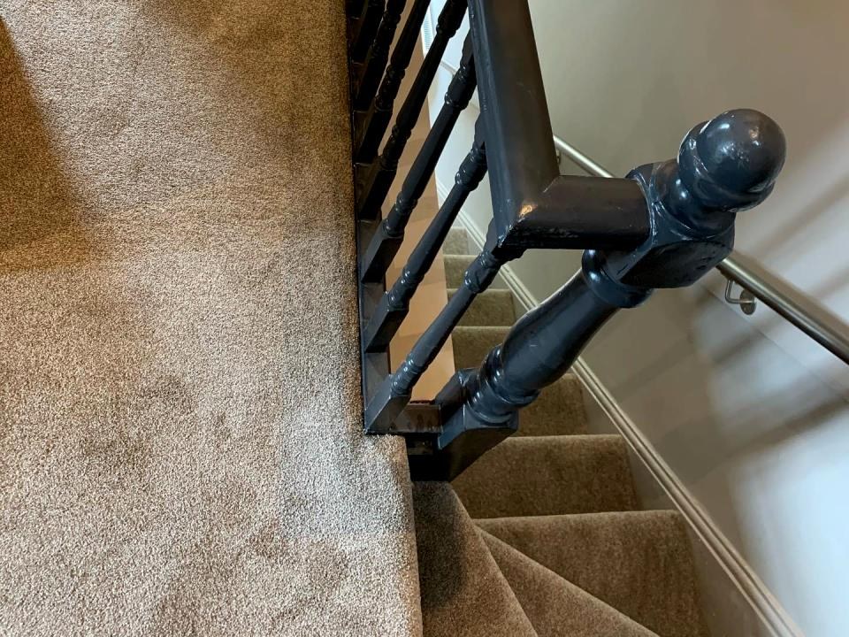 Soft carpet on a landing with a black banister